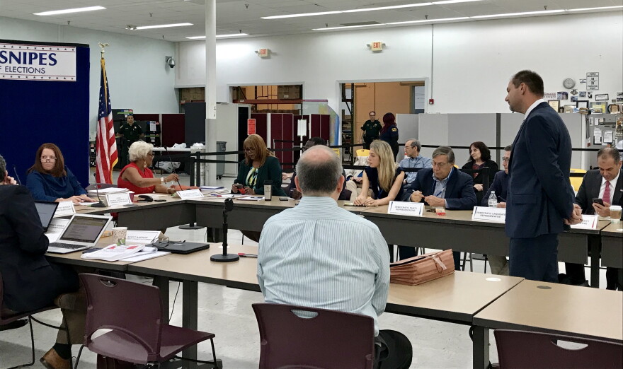 Sunday morning Joseph D'Alessandro, director of election planning and development, presented reults to the Broward canvassing board. He had to manually fix some results and generate a new report.