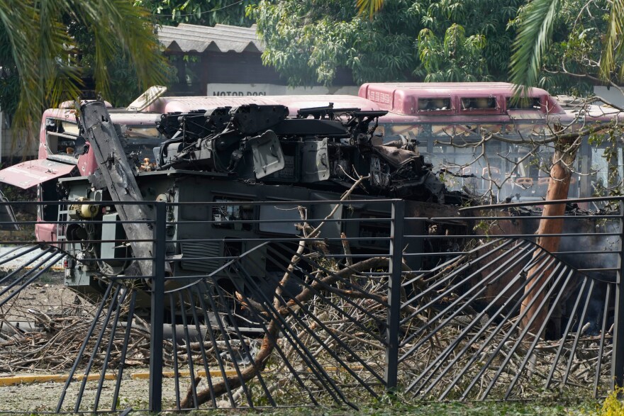 A destroyed armored vehicle sits at La Carlota airport in Caracas, Venezuela, Saturday, Jan. 3, 2026, after explosions were reported at the site.