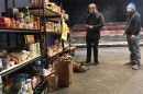 Actors Jake Walker and J. Will Fritz check out the inventory in the Theatre Community Fund of Kansas City's food bank, currently housed inside the Unicorn Theatre's Jerome Stage.