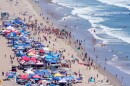 Beach goers watch during the the 46th Annual California Surf Lifesaving Championships on Will Rogers State Beach Friday, July 24, 2026, in the Pacific Palisades section of Los Angeles.