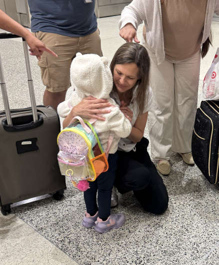 Little Crisitina meets volunteer Audra Obando at the MIA airport before their flight.