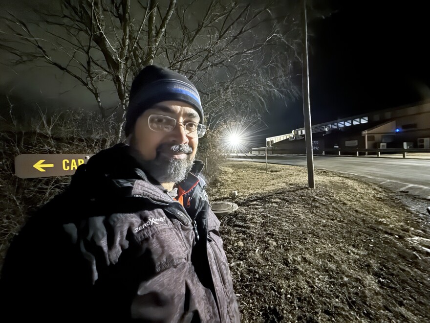 Astronomy professor Vayujeet Gokhale poses near a light that causes excessive glare, skyglow and disruption to wildlife at Thousand Hills State Park’s marina. The park is switching to lighting that works better for human eyes and the environment.