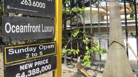 FILE — This file photo shows a real estate sign advertising an oceanfront home for sale at $4.38 million in Kailua, Oʻahu, Hawaiʻi.