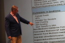 Family and Social Services Administration Secretary Mitch Roob walks through slides about how a federally mandated phase-down in the hospital assessment fee might impact the Healthy Indiana Plan, or HIP, at FSSA’s quarterly financial meeting on Tuesday, Oct. 27, 2026.