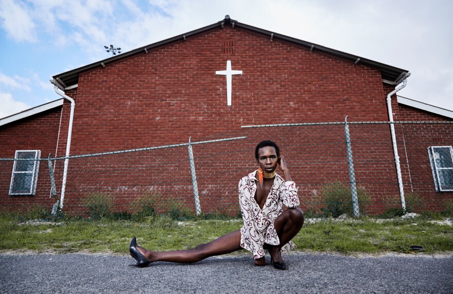 Mandisi Dolle Phika, 27, asked to be photographed by a church, an important place to her family but a place where she says she has faced anti-queer bias. At Catholic school, she remembers, "I once overheard a conversation where it was said I have a 'gay-demon.'" Now studying LGBTQI political leadership, she believes in "a colorful God" that "celebrates diversity in all its manifestations."