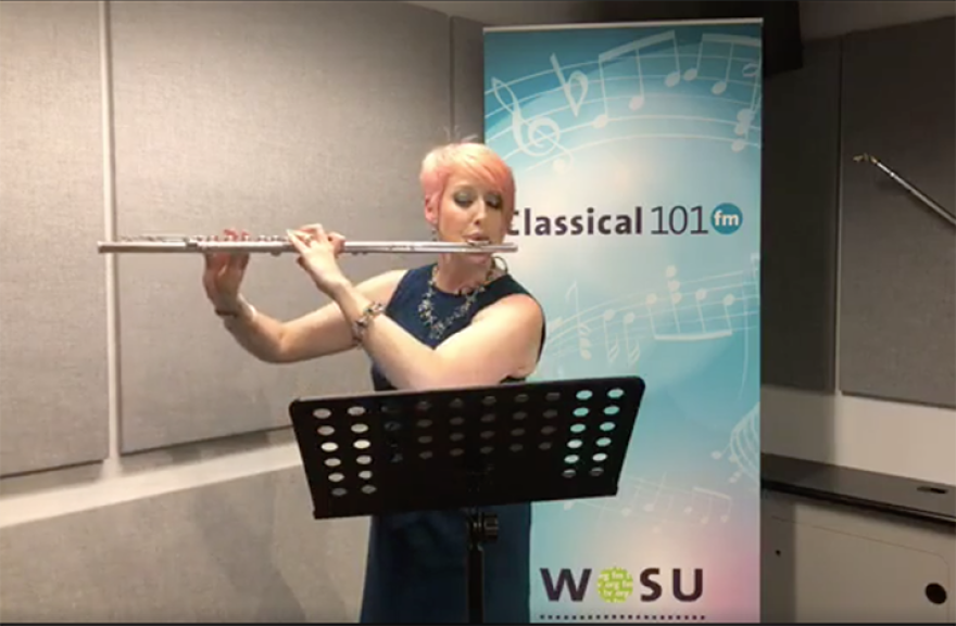 color photo of lindsey goodman playing her flute in the classical 101 studio