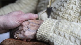 A woman, suffering from Alzheimer's desease, holds the hand of a relative on March 18, 2011 in a retirement house in Angervilliers, eastern France.  (Sebastien Bozon/AFP via Getty Images)
