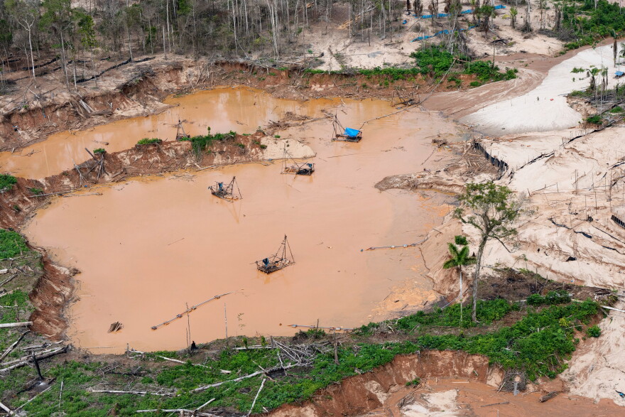 FILE - Dredges used for illegal mining sit near the Malinowski River in the Tambopata National Reserve in Puerto Maldonado, Peru, Aug. 11, 2026.