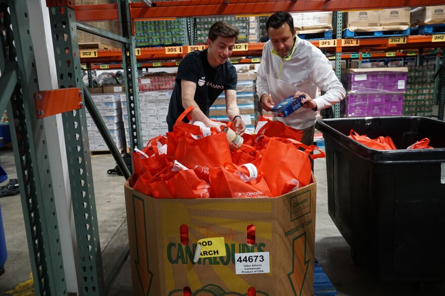 Nov. 19, 2018 at Operation Food Search: Andrew Glantz, CEO GiftAMeal and food bank manager Mark Taylor check bags for weekend meal program.