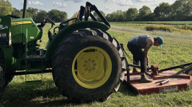 A farmer works on a tractor at Larissa Duprey's 12-acre farm in Yellow Springs.