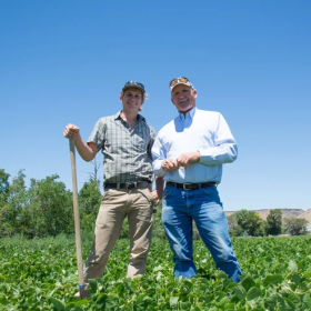 Wilder and his dad, Nate, pose in their fields.