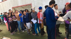 Central American migrants line up to apply for jobs at a job fair in Tijuana, Mexico. More than two thousand migrants have applied for a one-year humanitarian visa that would allow them to hold jobs legally in Mexico.