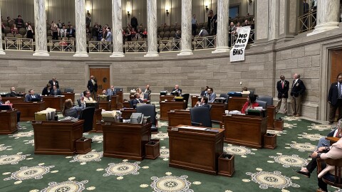 Abortion rights protesters unfurl a banner right after Missouri Republican senators passed a measure that, if approved by voters in 2026, could ban most abortions in the state.