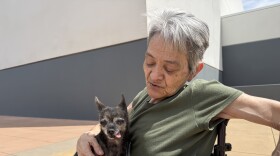 Stead resident Cecilia Leal-Covey evacuated from the Hawk Fire with her dad and chihuahua, Lola, on Aug. 22, 2026. They slept at the evacuation site at the Reno-Sparks Convention Center and planned to stay for several nights.