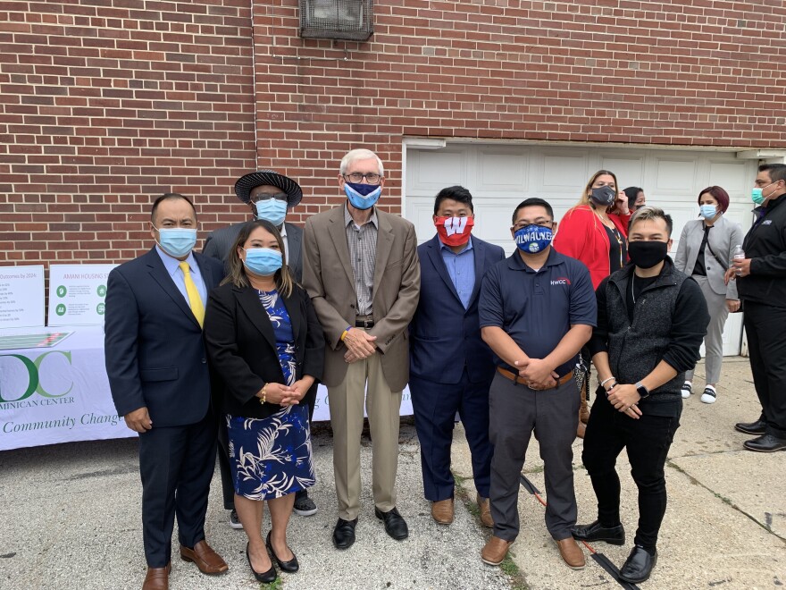 From left to right: Chimeng Yang (HWCC Vice President), Terrence Moore (HWCC Business Development Coordinator), Maysee Herr (HWCC Executive Director), Gov. Evers, Ger Thao (HWCC Operations Manager), Yuli Her (HWCC Business Development Coordinator) and Jim Lee (HWCC Marketing Coordinator)