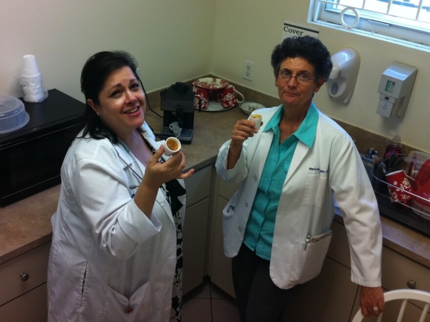 (From left): Maria Torres and Maria Menendez drink Cuban coffee in Miami. Both are nurse practitioners at the San Juan Bosco Clinic.
