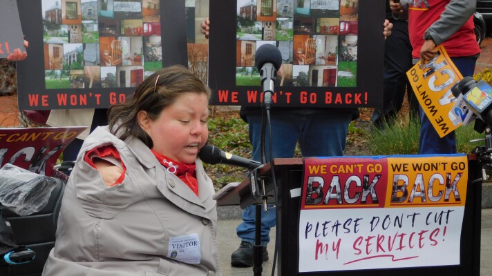Danielle Bustos, who has been utilizing self-directed developmental disability care since 2015, speaks against budget cuts to the Maryland Developmental Disabilities Administration on Thursday outside the State House in Annapolis, Md.