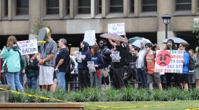 Protesters held signs silently in front of Cleveland State's Student Center. Many expressed outrage and sadness of at the abrupt closure and sale of the university's WCSB 89.3 to Ideastream Public Media.