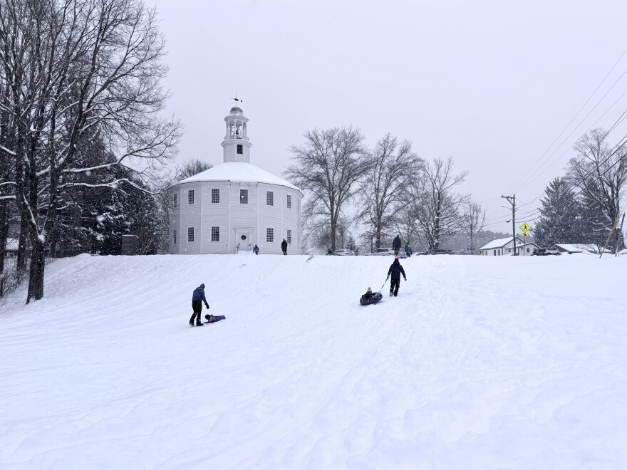 Families go sledding at the Round Church in Richmond on Monday afternoon.