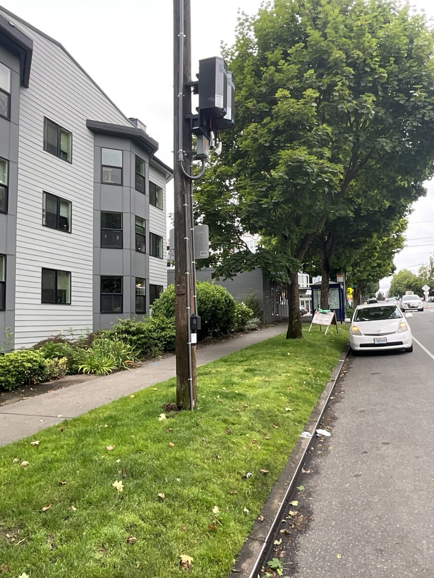 Twelve of the 31 curbside chargers that Seattle City Light is installing will hang overhead on wooden utility poles, with an app-activated switch to lower the cable and plug in to a vehicle. This novel design works best in some dense neighborhoods.