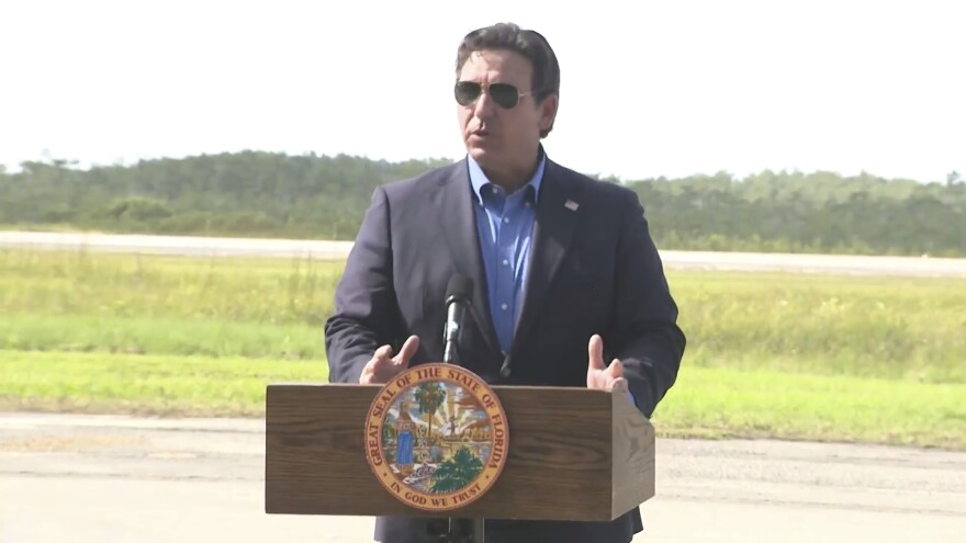 FILE - This image from a video feed shows Gov. Ron DeSantis speaking about deportation flights from the remote Everglades immigration lockup known as "Alligator Alcatraz″ on July 25, 2025 in Ochopee, Florida. (Office Of Florida Governor Ron Desantis via AP, file)