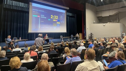 Frank Demenge speaks into a microphone at the DNR public comment meeting.