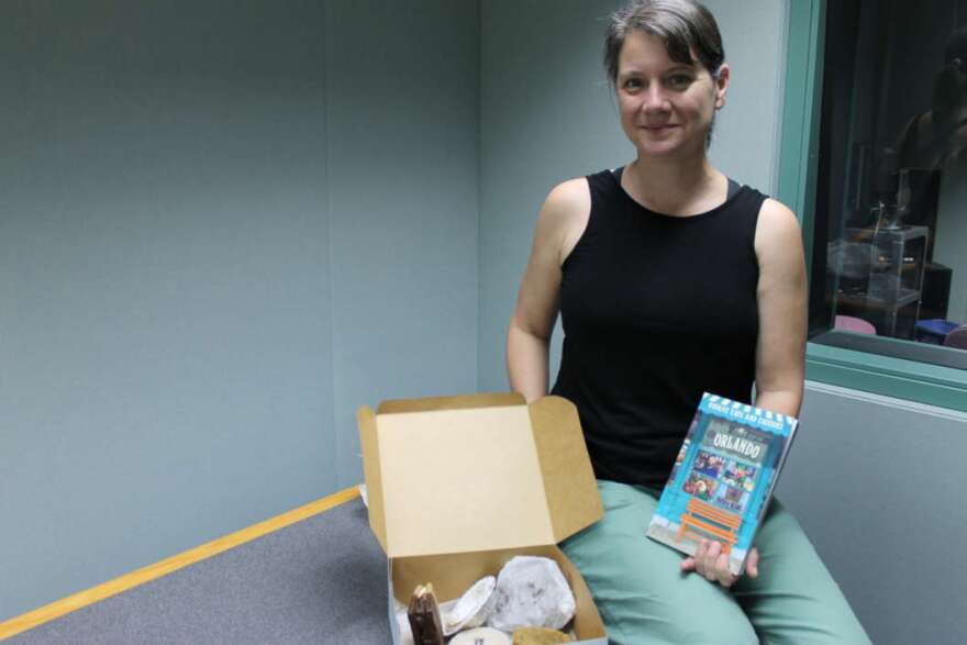 Kendra Lott with some unique eats from one of the eateries featured in her new book. Photo: Matthew Peddie, WMFE