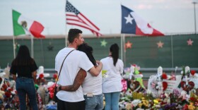 People gather at a makeshift memorial honoring victims outside Walmart on August 15, 2019 in El Paso, Texas. Twenty-two people were killed in the Walmart during a mass shooting on August 3. (Sandy Huffaker/Getty Images)