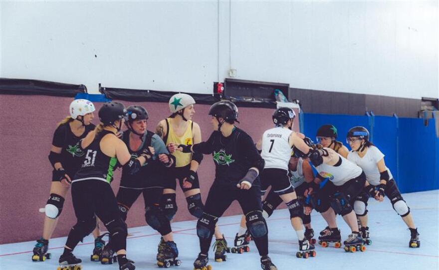 A group of women play roller derby.