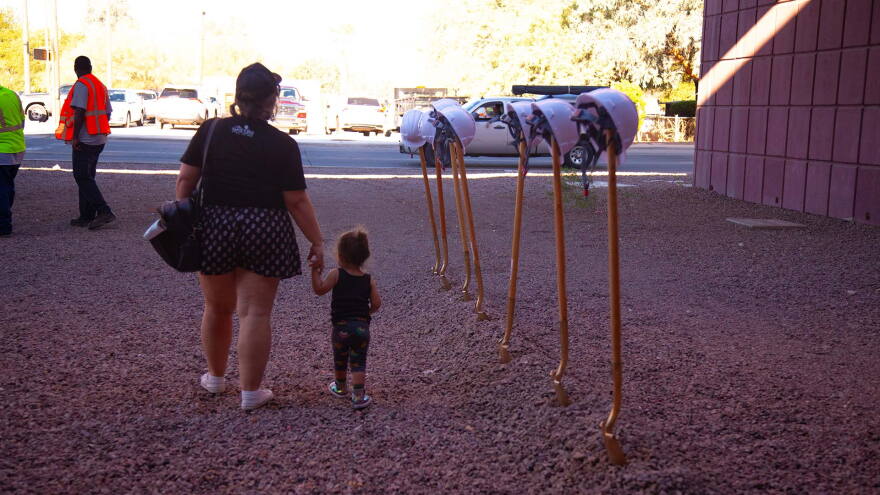 Mom and kid by gold shovels