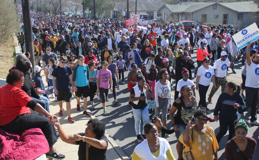 Onlookers encourage marchers along the way