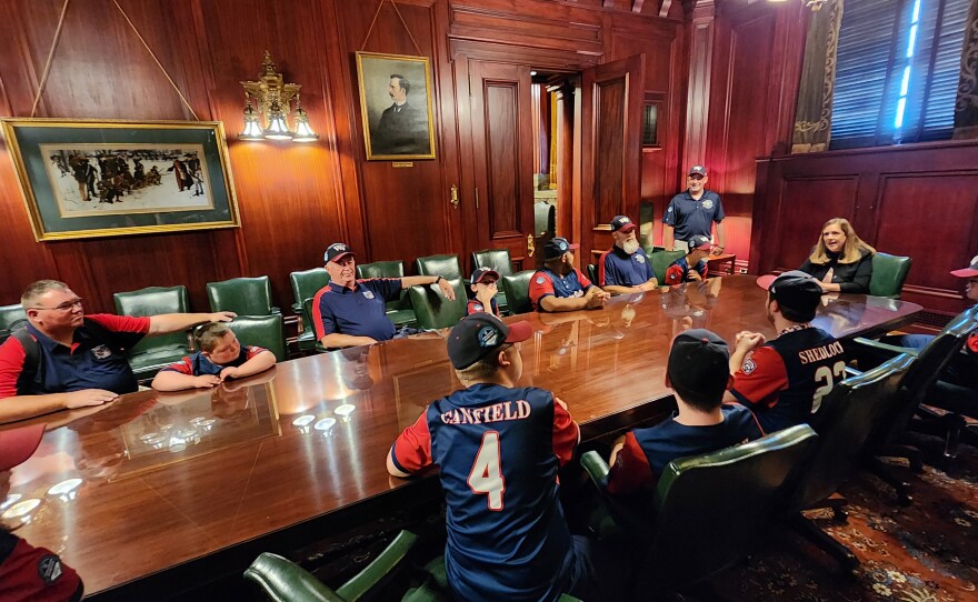 Members of the Wyoming Valley Challenger team sit at a table with Sen. Lisa Baker.