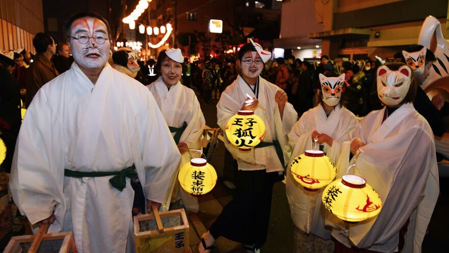 Residents in fox makeup participate in the Oji Fox parade to thank the outgoing and welcome the incoming year at the Oji Inari shrine in Tokyo.