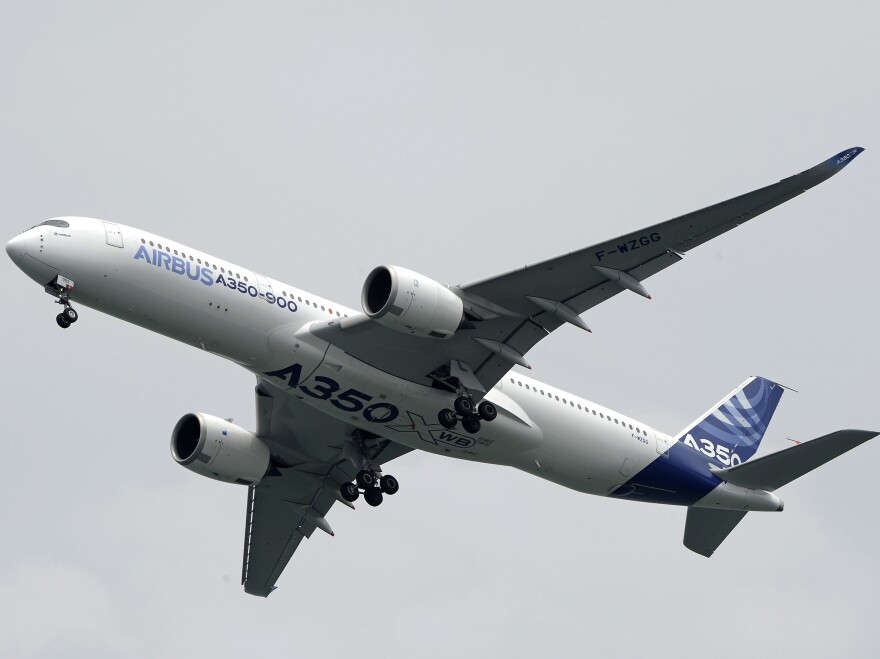 The Airbus A350-900 flies in the aerial display on the first day of the Singapore Air Show in February. Dubai-based Emirates Airlines announced Wednesday it was canceling an order for 70 of the planes.