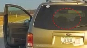 A photo from the special prosecutor’s statement shows Huttle on dash camera footage reaching into his vehicle at the traffic stop.