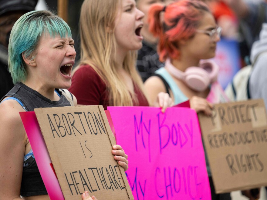 Abortion-rights supporters chant Thursday in front the Supreme Court building.