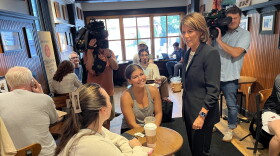 Helena Foulkes talks to patrons at Coffee Exchange in Providence the morning after her primary win. Credit: Ian Donnis/Ocean State Media