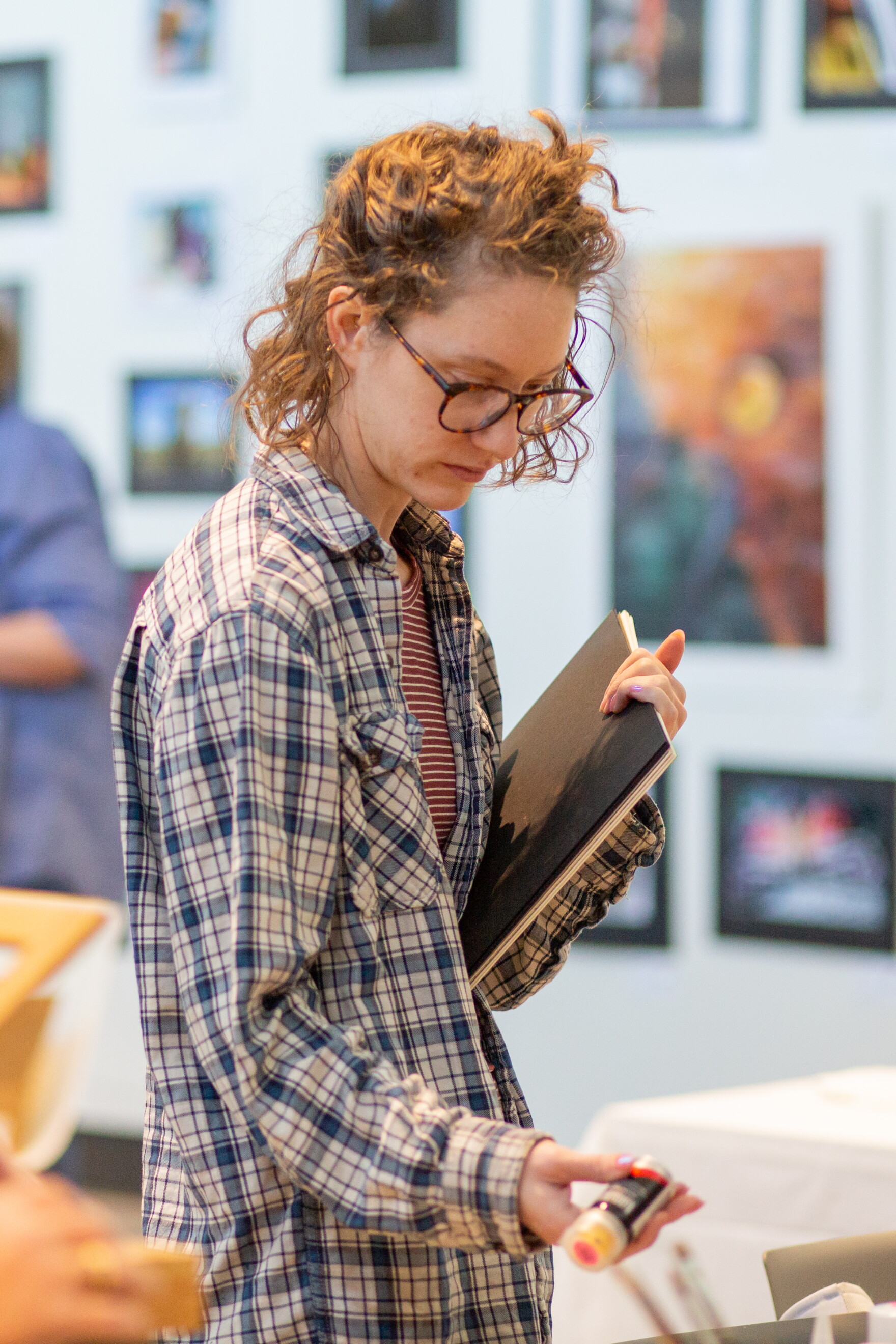 Abby Ausherman, a WSU master's printmaking student and local art teacher, picks up art supplies at a Wichita Women Artists meeting on March 20. Alongside regular critique and updates, WWA hosted an in-group sale of its art supplies.