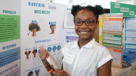 A child presents at a science fair.