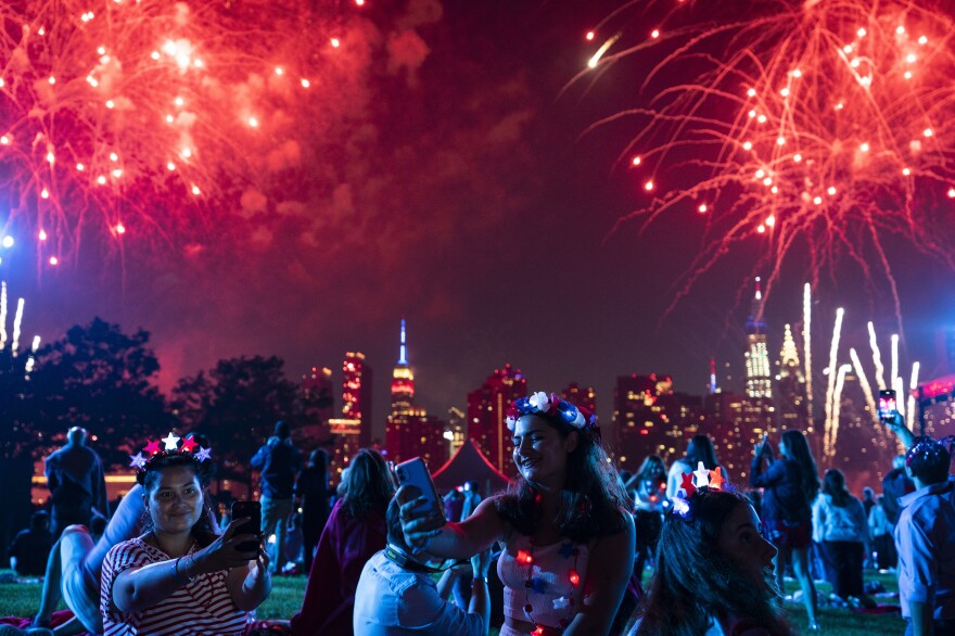 Spectators watch as fireworks are launched over the East River and the Empire State Building in New York City on July 4, 2021. Regulators are warning people ahead of July Fourth to be careful handling any recreational fireworks.