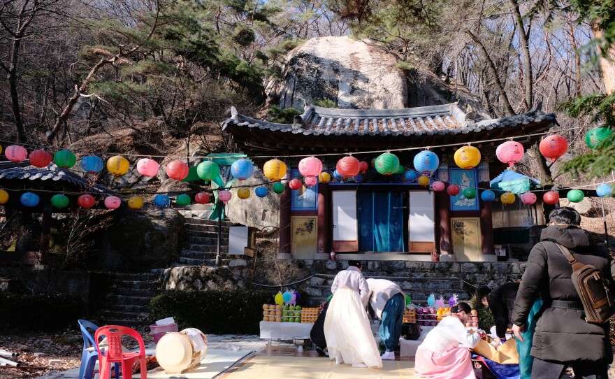 Participants clean up following a shamanic initiation ceremony at a temple in Seoul.