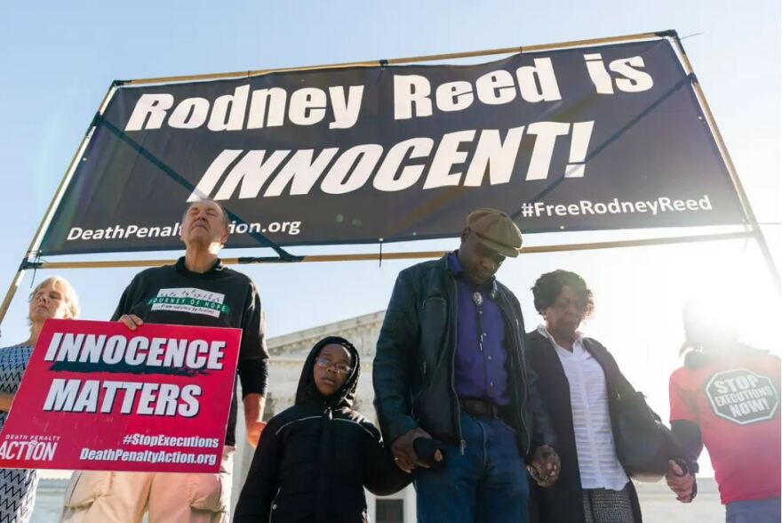 Family members of Rodney Reed, center, join hands as they pray during a rally at the U.S. Supreme Court in Washington, D.C., on Oct. 11, 2022.