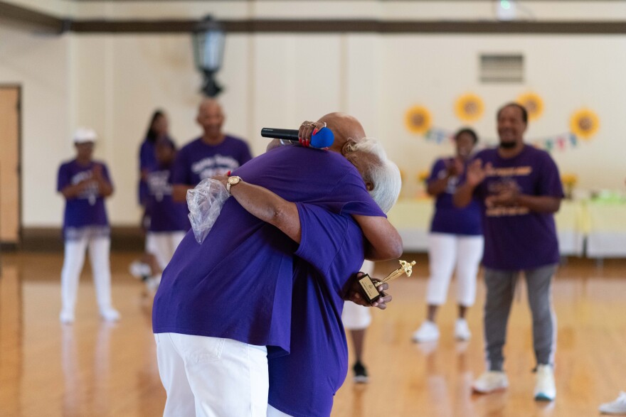 Members of the line-dancing group give each other a hug during the class. They say it’s important to celebrate each other’s successes together.
