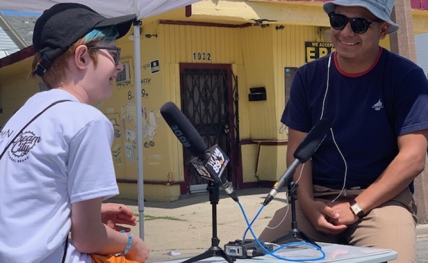 Community Engagement Coordinator Rafa Muñoz sits down with a young WUWM listener at Heal the Hood.