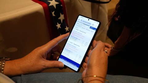 A supporter follows election voting results during an election night watch party for Sen. Bill Cassidy, R-La., Saturday, May 16, 2026, in Baton Rouge, La.