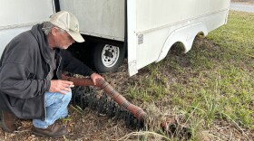 Robert Kritzrow, 62, explains how his RV connects to the septic system in the ground. Residents do not have to do any maintenance of the septic tank itself.