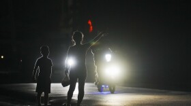 Blackout Blues: A woman and a boy attempt to hitch a ride during a scheduled power outage in Bauta, Cuba, on Monday, March 18, 2024, as the island's energy crisis worsens amid its deepening economic collapse.