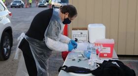 An image of a worker preparing vaccinations