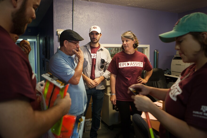 Juan Parras, left, the executive director of Texas Environmental Justice Advocacy Services, or TEJAS, talks with Kahler Stone and Jennifer Horney, part of a group from Texas A & M University who do soil and water testing in the Manchester neighborhood.