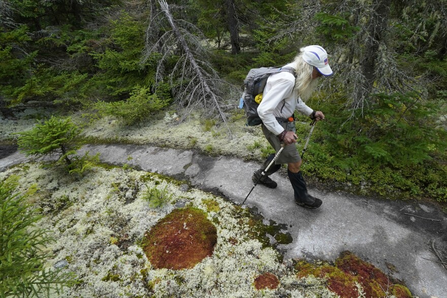 FILE - M.J. Eberhart, 83, carefully hikes the Appalachian Trail, Sept. 12, 2021, in Gorham, New Hampshire. (AP Photo/Robert F. Bukaty, File)